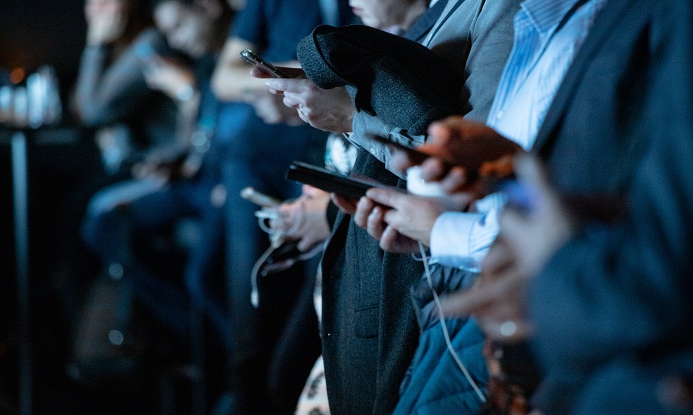 A group of people holding smartphones.