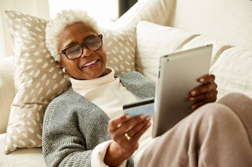 older woman smiling while online shopping